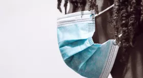 woman in mask wonders if she can be fired for missing work due to COVID-19