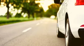 white car on New Jersey road driving safely