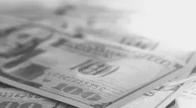 greyscale photo of US $100 bill