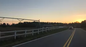 car driving at dusk on rural undivided road