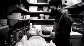 Dishwasher at restaurant. Burns, falls and strains are common injuries for foodservice workers