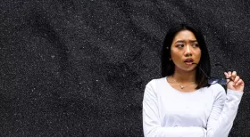 woman in white shirt wonders if she should hire a car accident lawyer