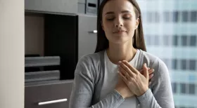 Woman relieved with heart on chest after receiving settlement from NY car accident