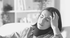 woman holding her head in pain after an accident and filing a personal injury claim