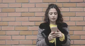 Woman looking at phone social media during lawsuit