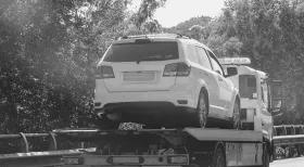 work vehicle loaded onto tow truck after car accident
