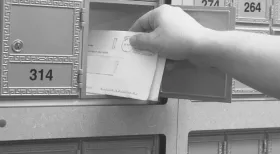 Person getting mail looking to receive a settlement check