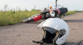 motorcycle accident in background with helmet on New York road