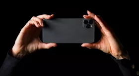 hands holding an iphone on black background