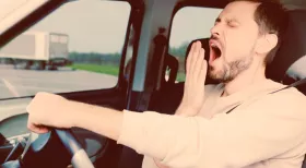 drowsy driver at the wheel of a car