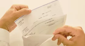 New Jersey worker examines paycheck for wage theft