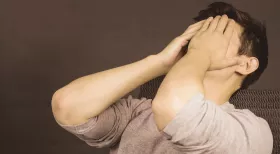 man holding hands over face for mistake after injury accident