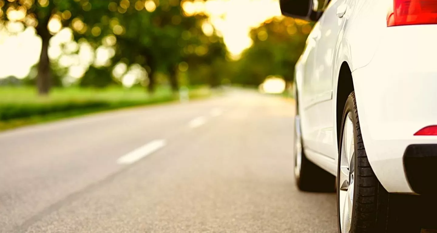 white car on New Jersey road driving safely