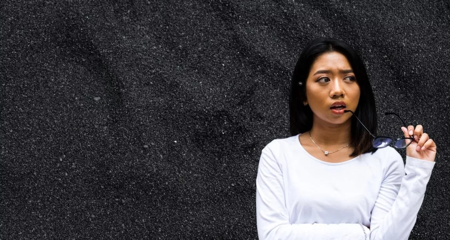 woman in white shirt wonders if she should hire a car accident lawyer