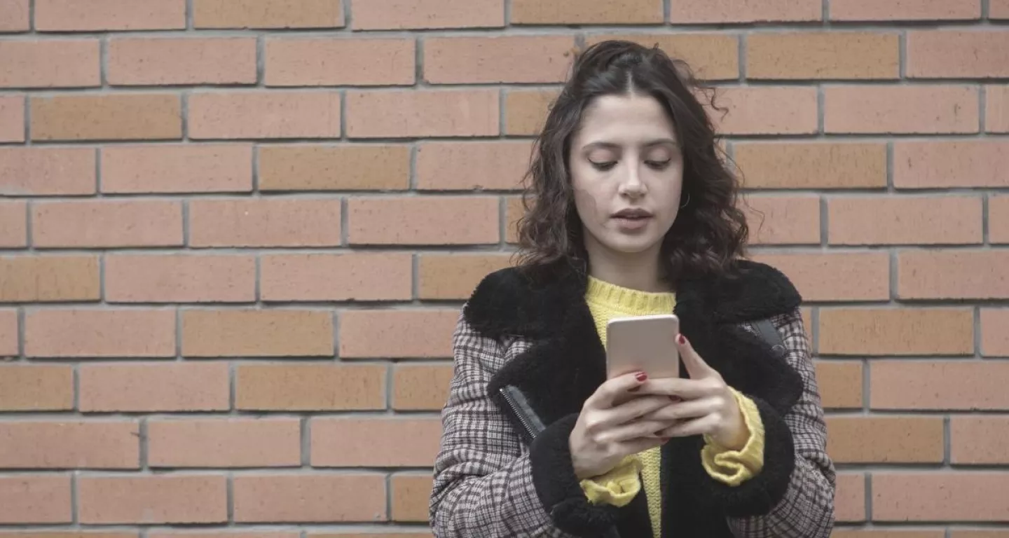 Woman looking at phone social media during lawsuit