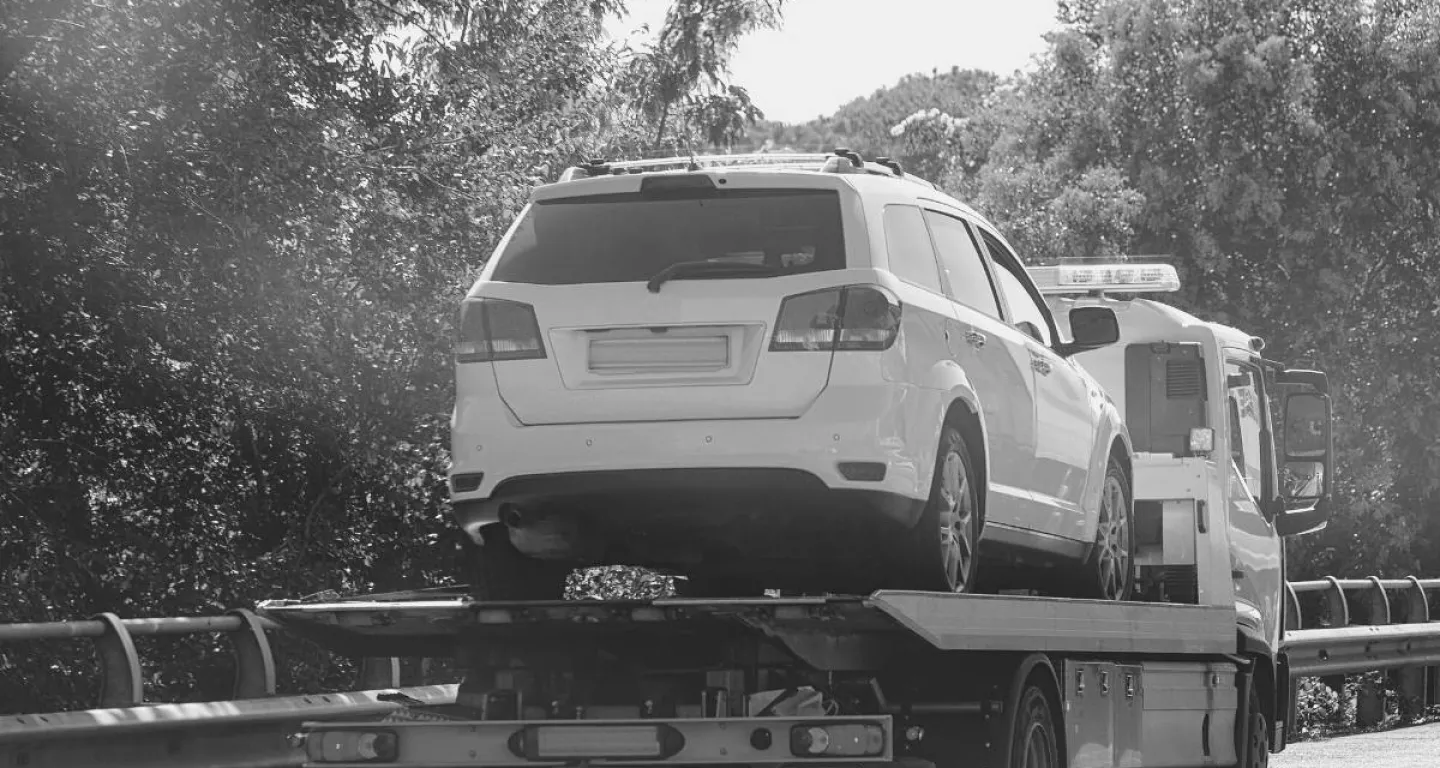 work vehicle loaded onto tow truck after car accident