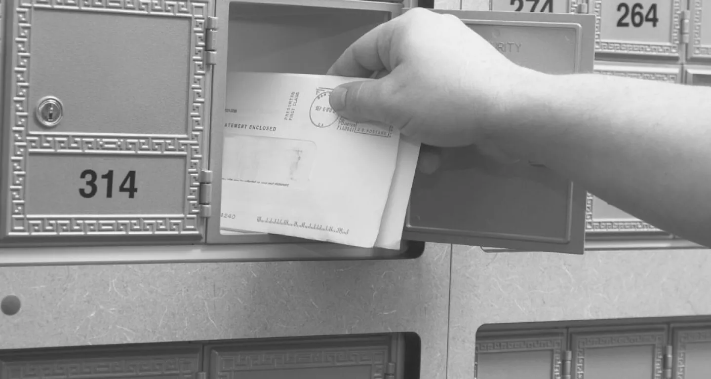 Person getting mail looking to receive a settlement check