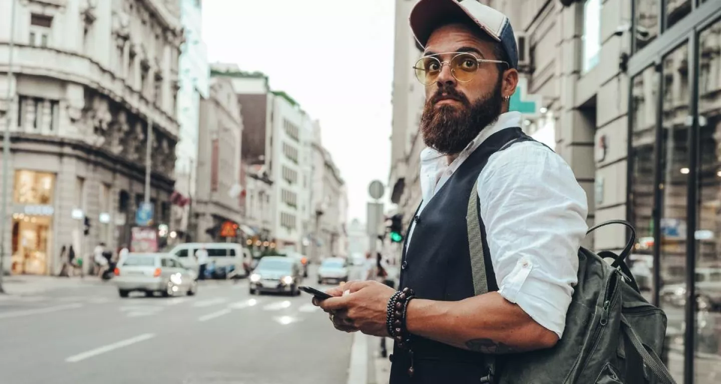 Man in New York looking down street waiting for Uber