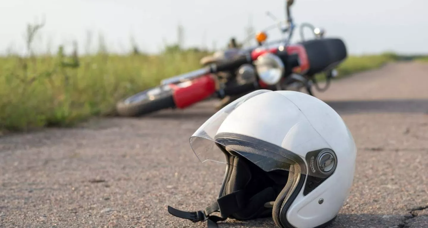 motorcycle accident in background with helmet on New York road