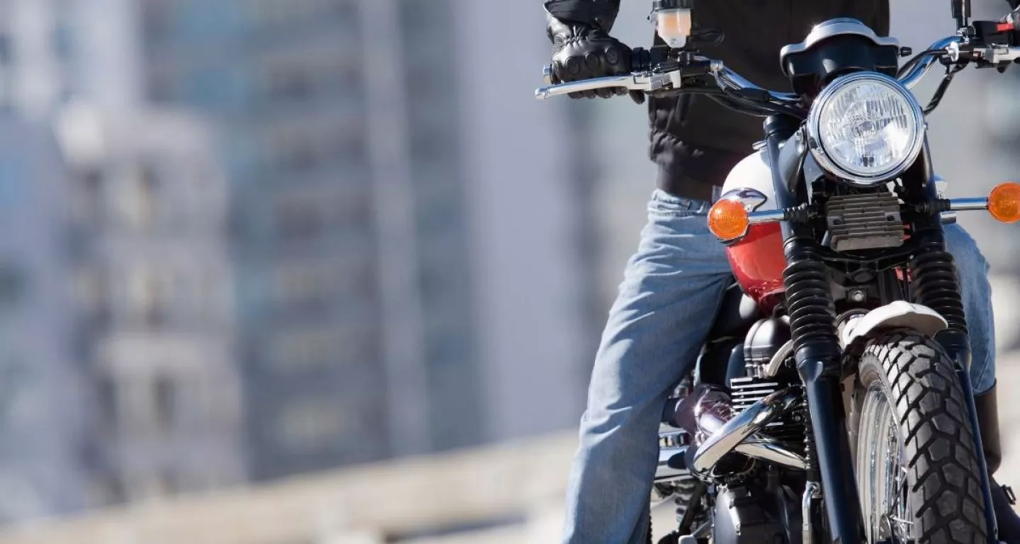 Motorcycle rider with New York buildings in background