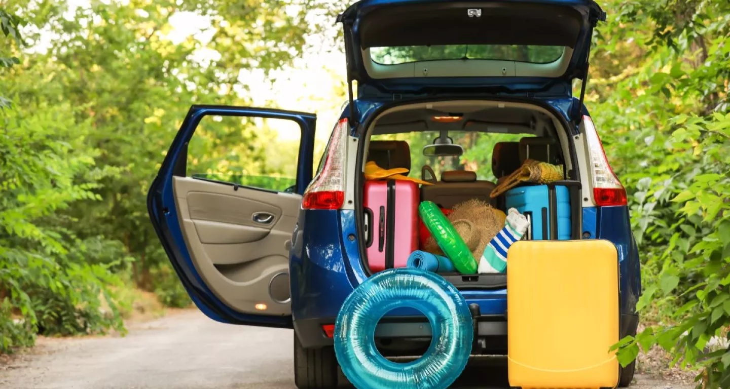 car packing up for summer driving with rafts and floats