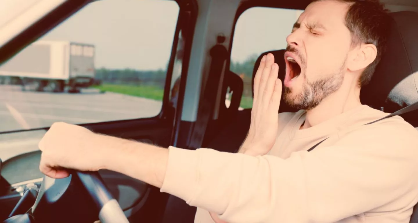 drowsy driver at the wheel of a car